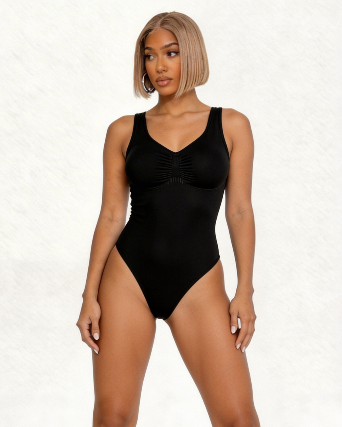 Woman wearing a black one-piece swimsuit on a white background