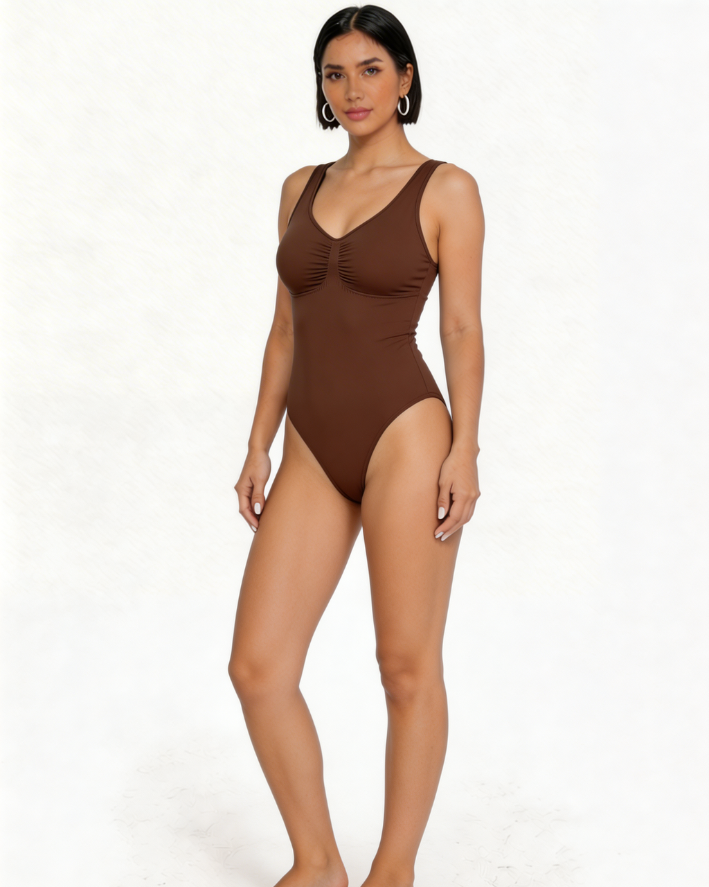 Woman wearing a brown one-piece swimsuit on a white background