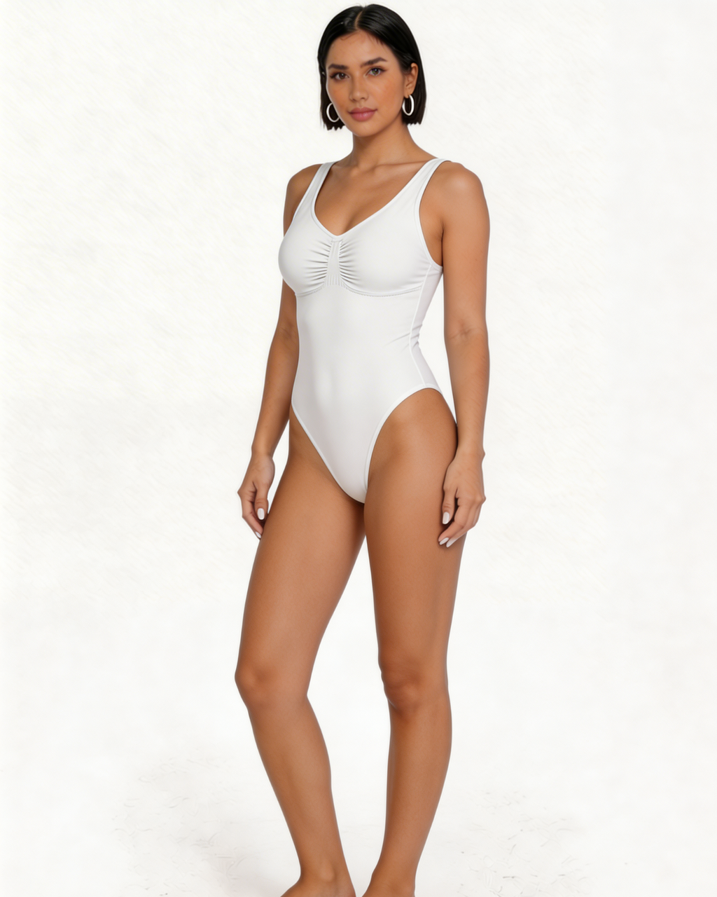 Woman wearing a white one-piece swimsuit on a white background