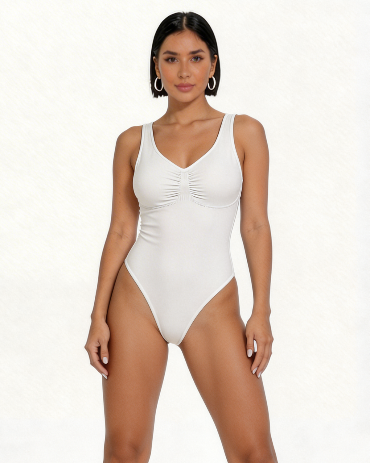 Woman wearing a white one-piece swimsuit on a white background